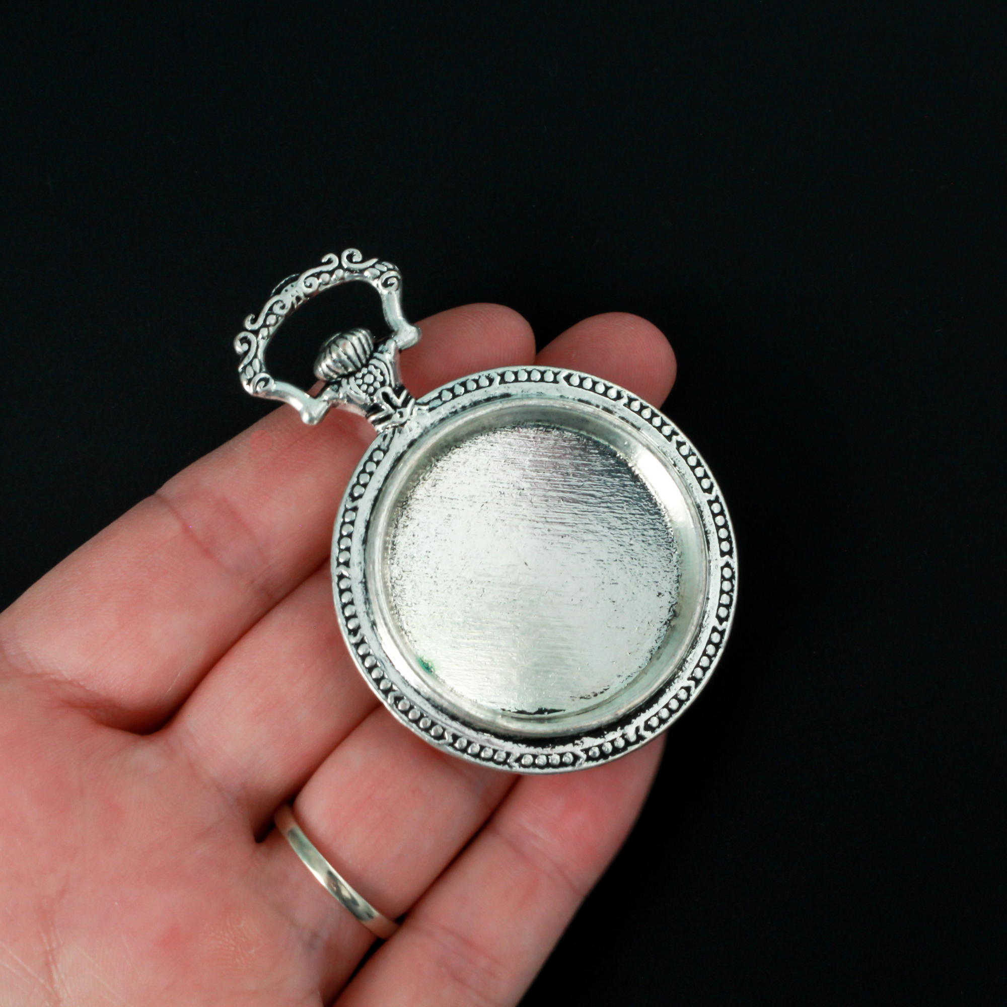 Large silver cabochon setting shaped like an old ornate pocket watch with a 33mm tray.