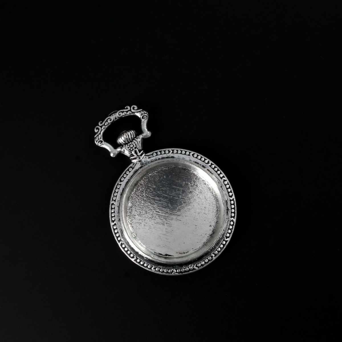 Large silver cabochon setting shaped like an old ornate pocket watch with a 33mm tray.