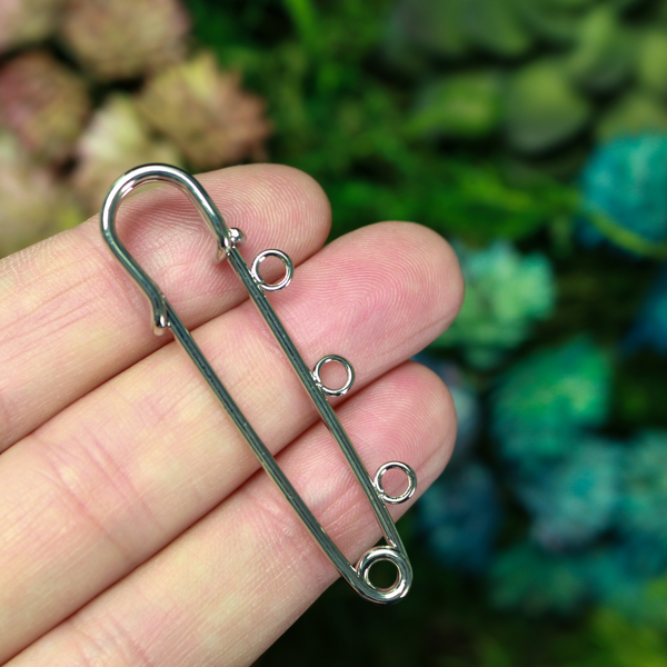 Safety pin brooch pin with three loops so you can easily attach your patron saint medals.