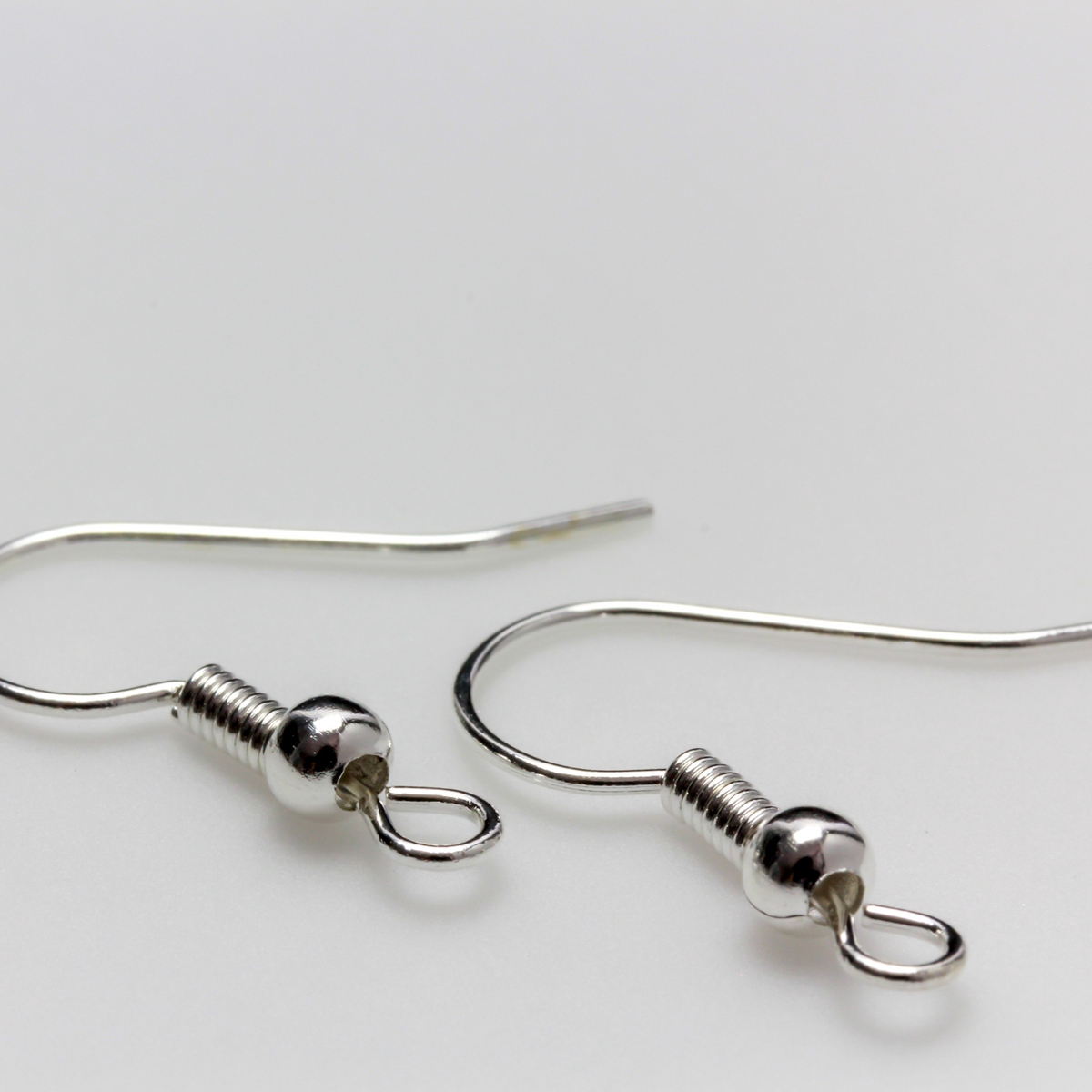 earring hooks with a horizontal loop and a shiny platinum silver finish, 23 gauge wire. Sold in packages of 30 hooks (15 pairs)