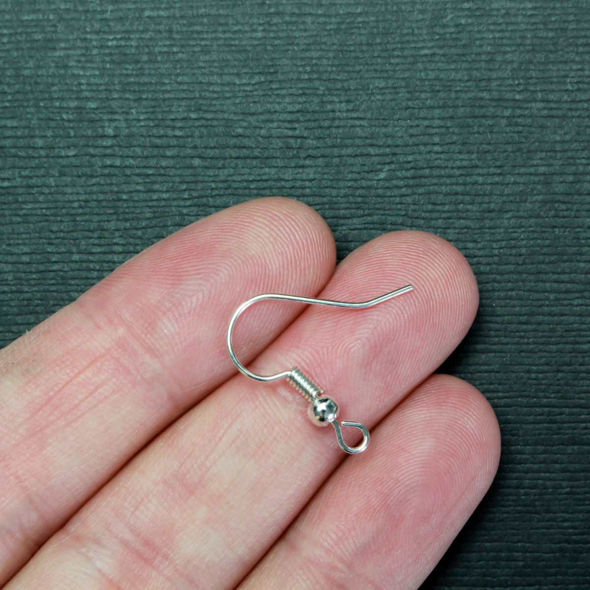 earring hooks with a horizontal loop and a shiny platinum silver finish, 23 gauge wire. Sold in packages of 30 hooks (15 pairs)