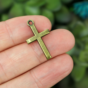 simple classic cross charm brass tone color