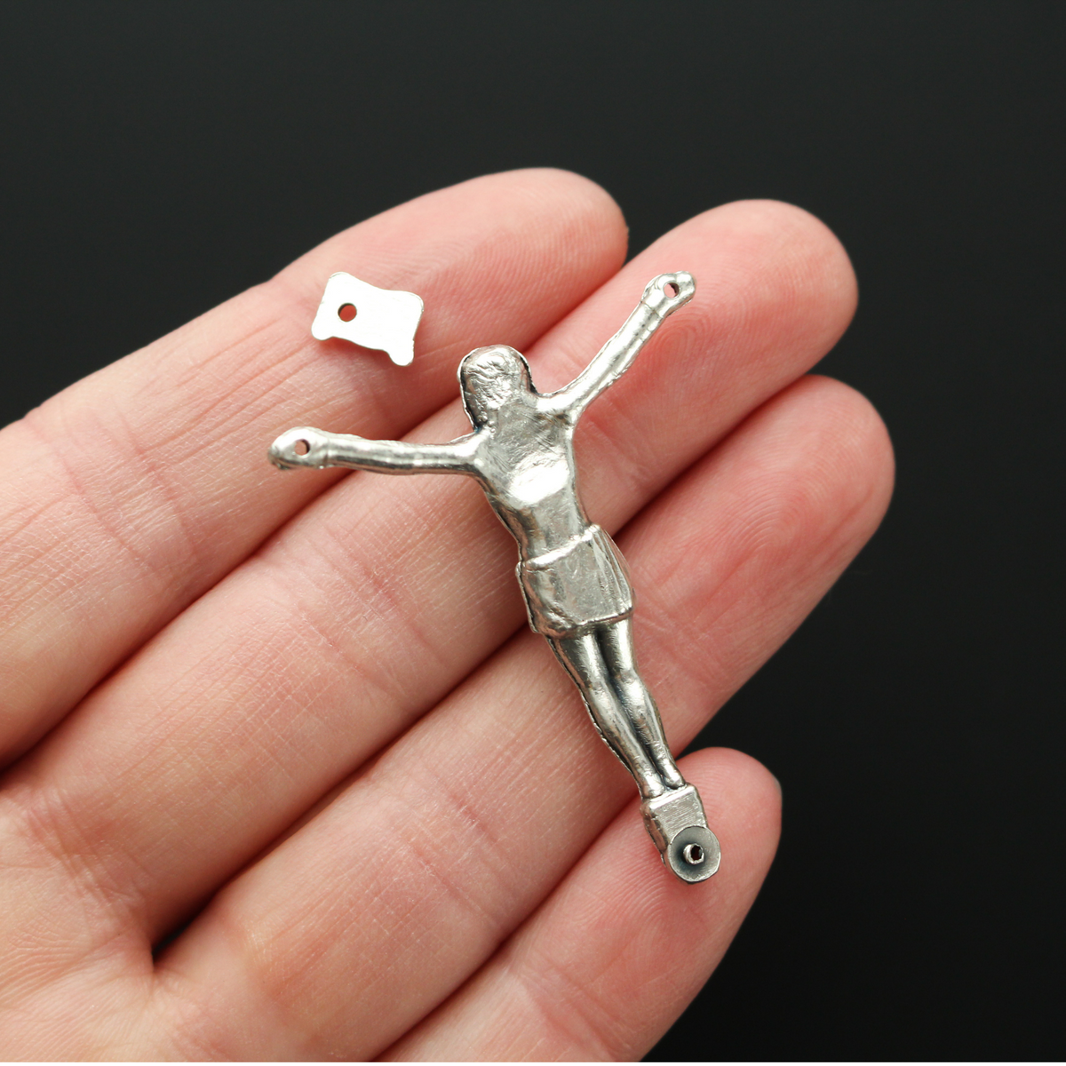 1.625" long corpus that comes with an INRI scroll that can be attached to a cross using the pre-drilled 2mm holes