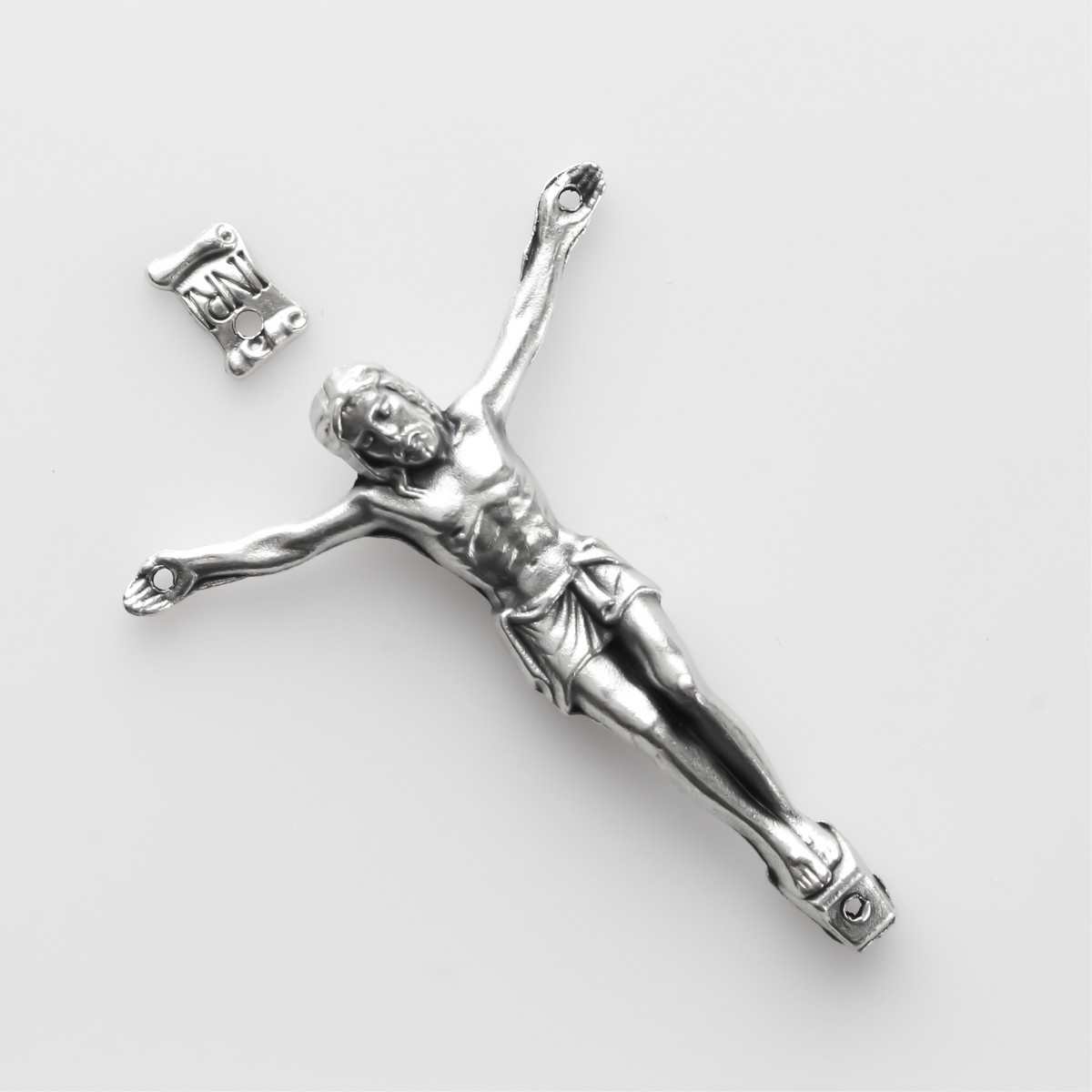 1.625" long corpus that comes with an INRI scroll that can be attached to a cross using the pre-drilled 2mm holes