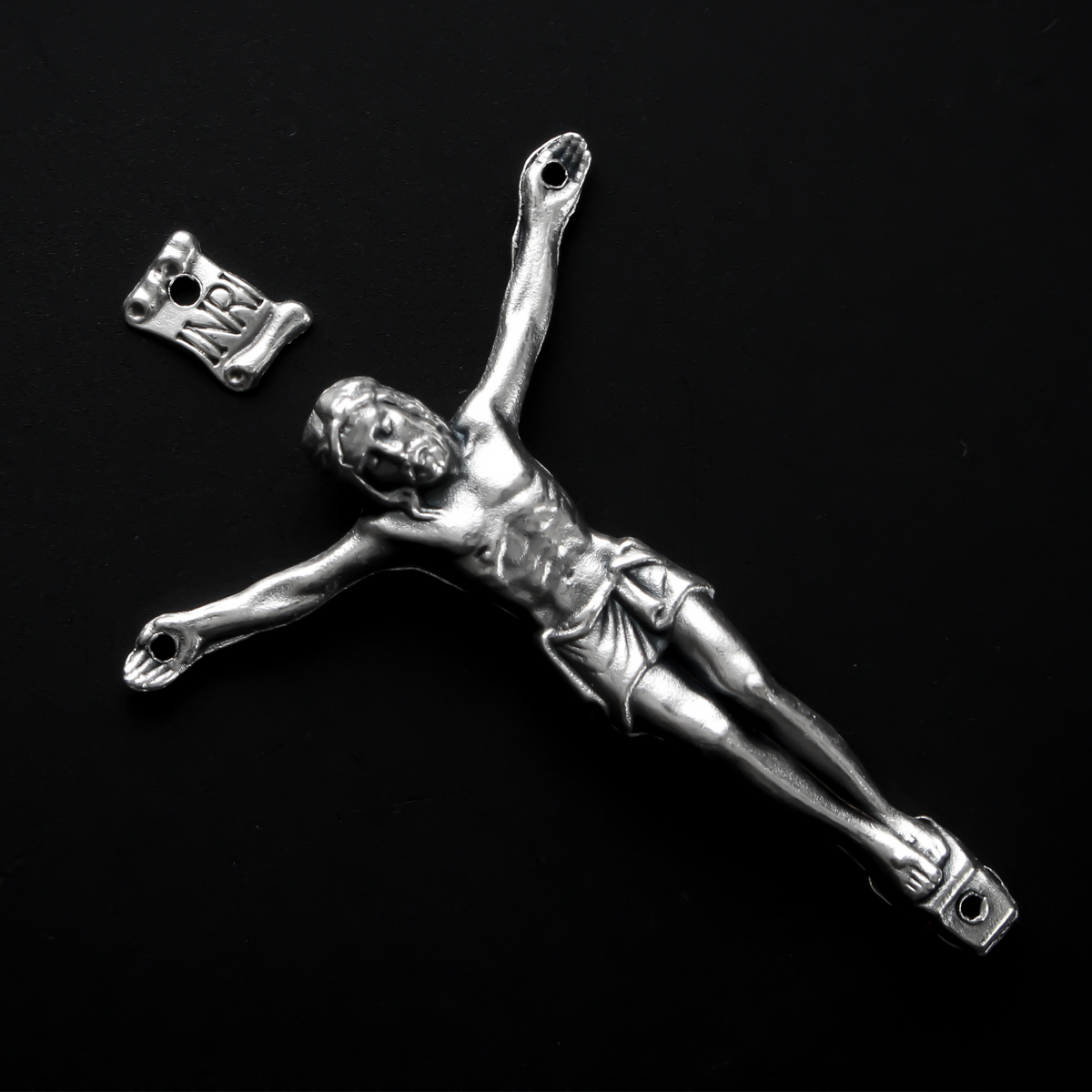 1.625" long corpus that comes with an INRI scroll that can be attached to a cross using the pre-drilled 2mm holes