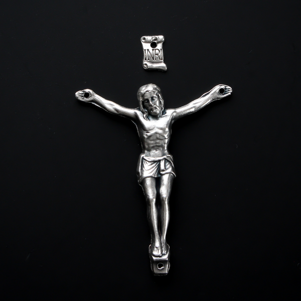 1.625" long corpus that comes with an INRI scroll that can be attached to a cross using the pre-drilled 2mm holes