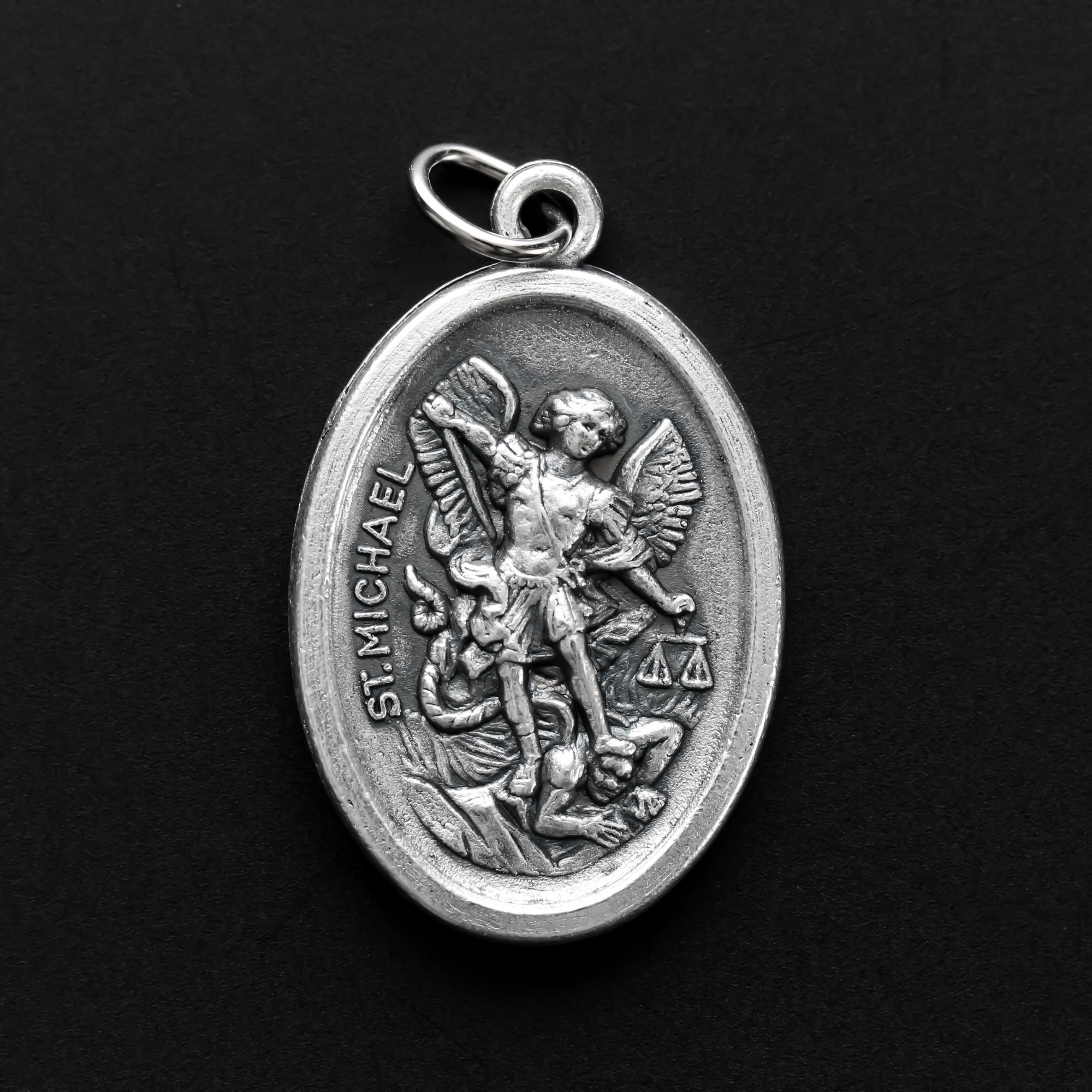 saint michael die cast silver tone one inch oval medal