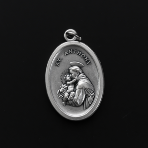 Saint Anthony of Padua oval medal that depicts the saint on the front and "Pray For Us" on the back