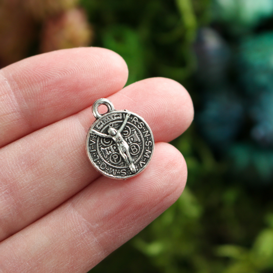 Round Saint Benedict medal with Crucified Jesus Christ on the backside