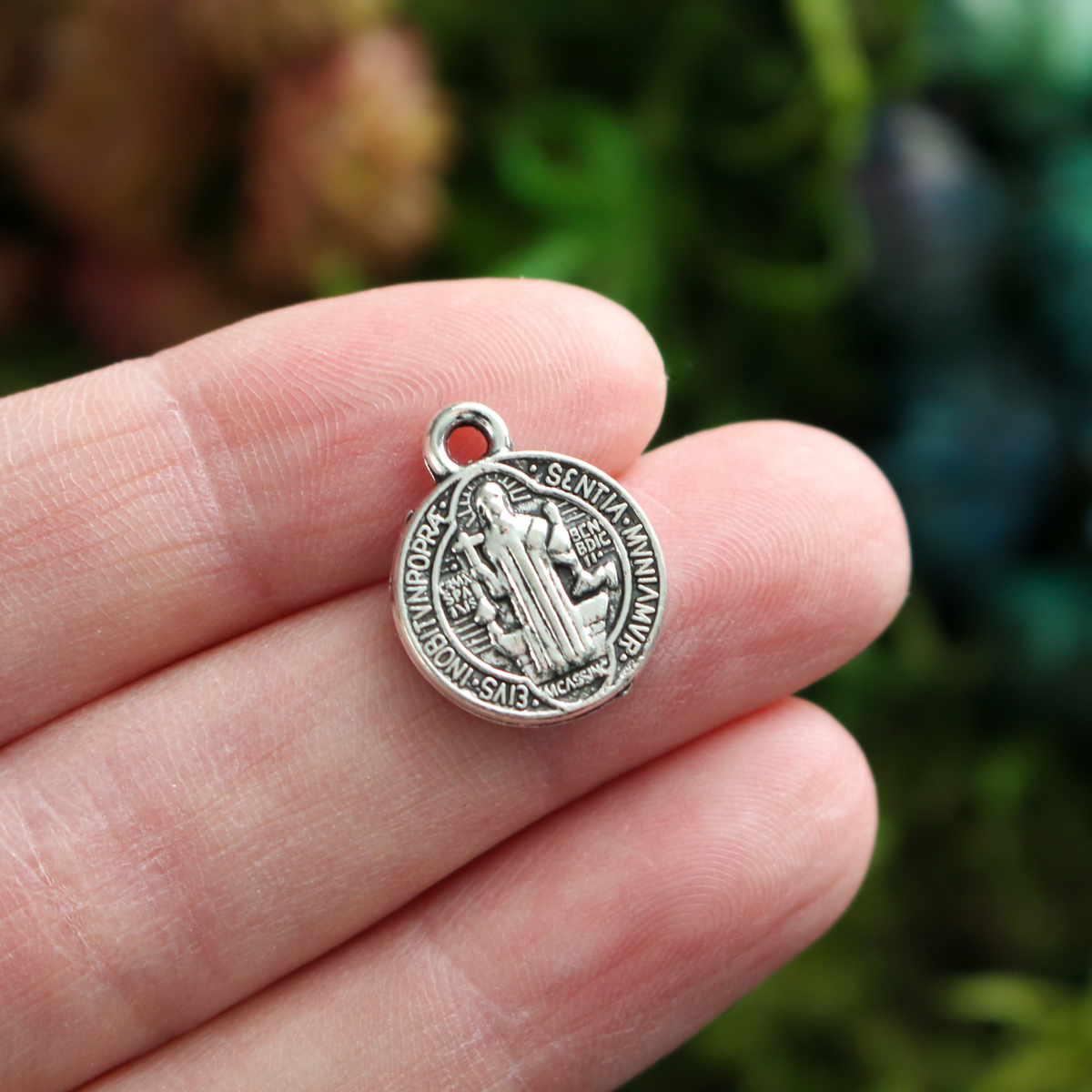 Round Saint Benedict medal with Crucified Jesus Christ on the backside