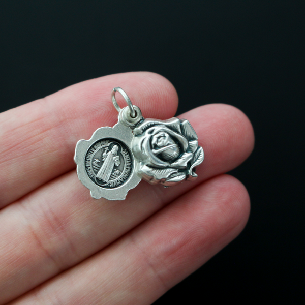 Saint Benedict medal rose locket that slides open to reveal the medal inside. It's a double-sided locket with a rose on both sides