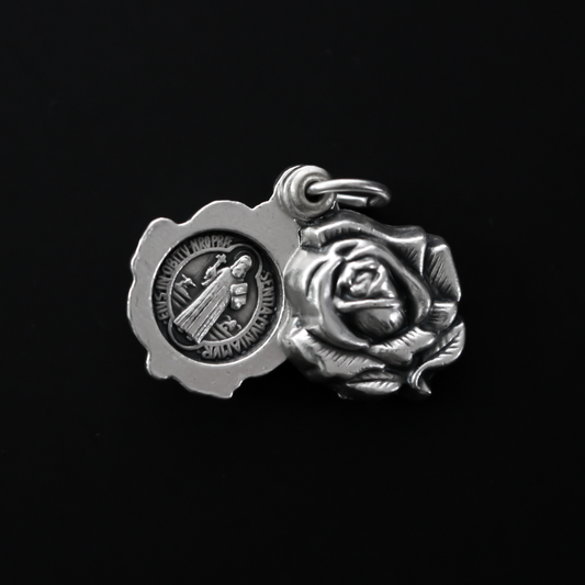 Saint Benedict medal rose locket that slides open to reveal the medal inside. It's a double-sided locket with a rose on both sides