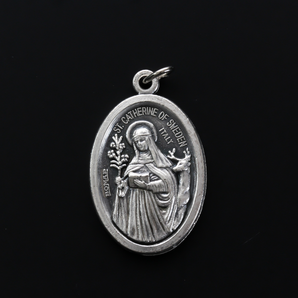 Saint Catherine of Sweden medal that depicts the saint on the front and is marked "Pray For Us" on the back