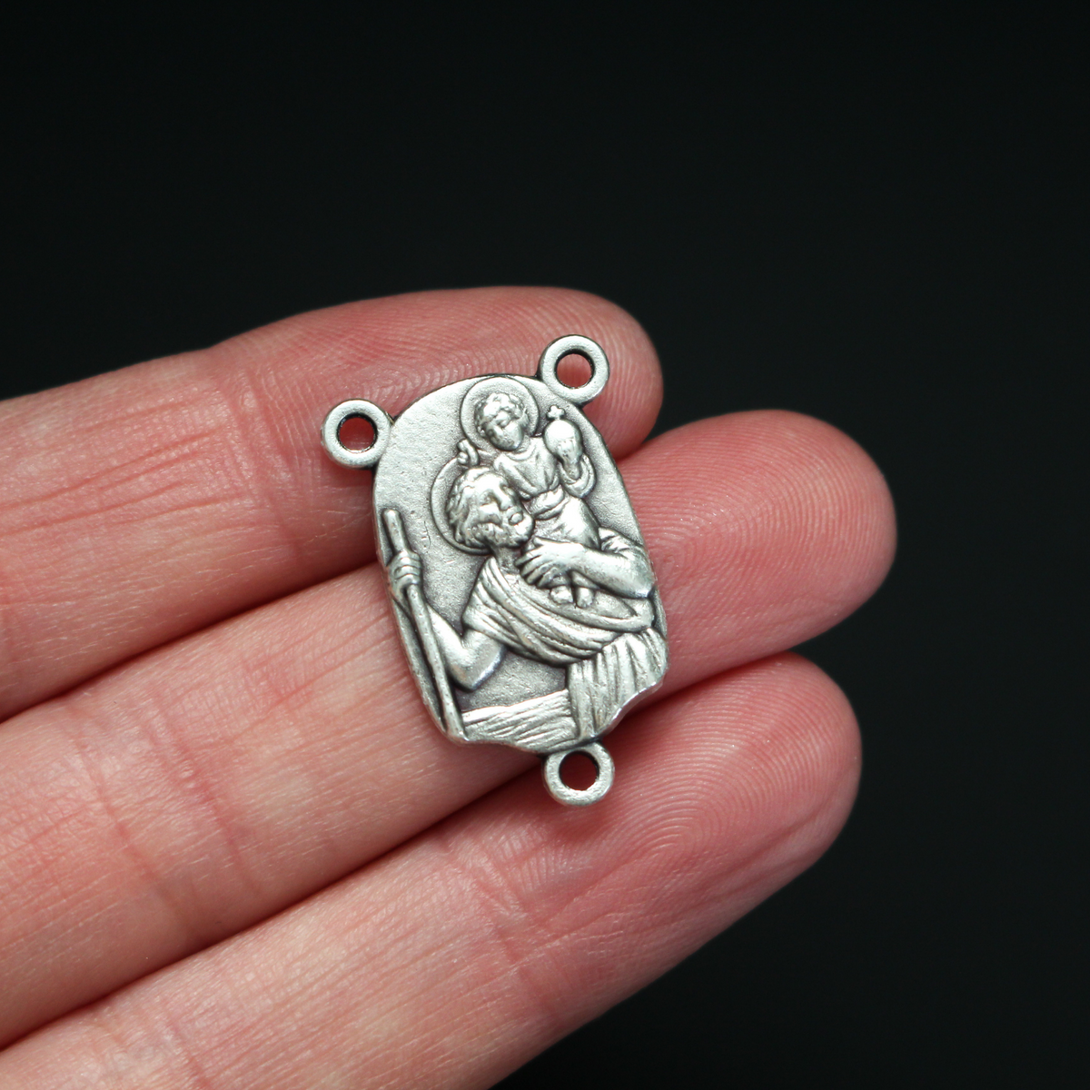 Rosary centerpiece that depicts St. Christopher with child Jesus on his shoulders on the front, the reverse is marked "Pray For Us"