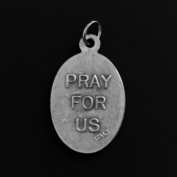 Saint Dominic Savio medal that depicts the saint on the front and "Pray For Us" on the back