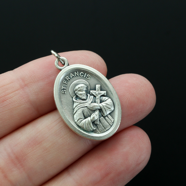 Saint Francis of Assisi medal that depicts the saint on the front and "Pray For Us" on the back