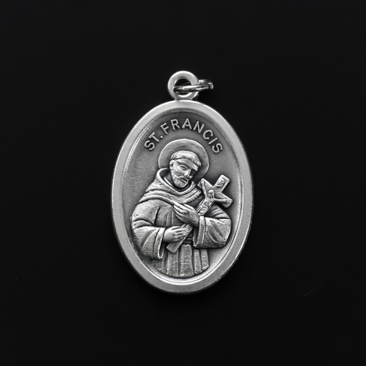 Saint Francis of Assisi medal that depicts the saint on the front and "Pray For Us" on the back