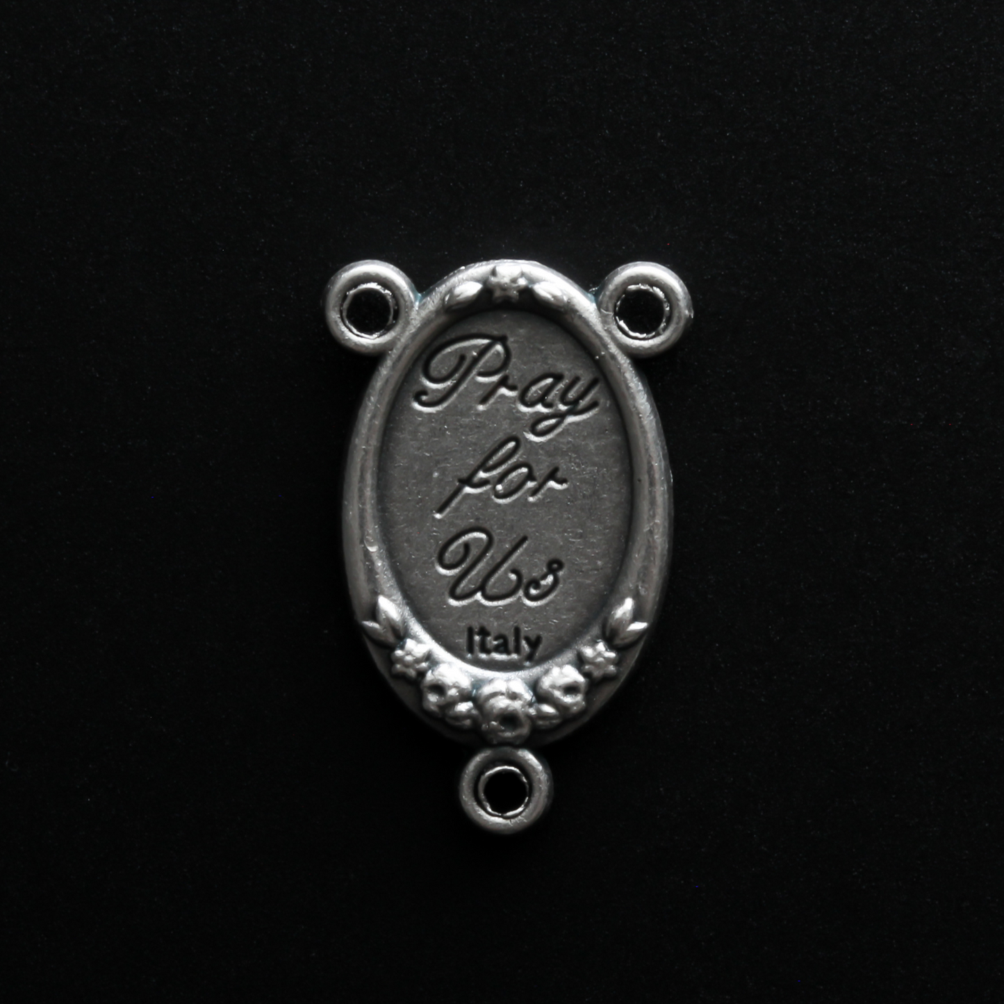 rosary center that has a full-color image of Saint Francis of Assisi inlaid in a silver oxidized center with flower details on the edge