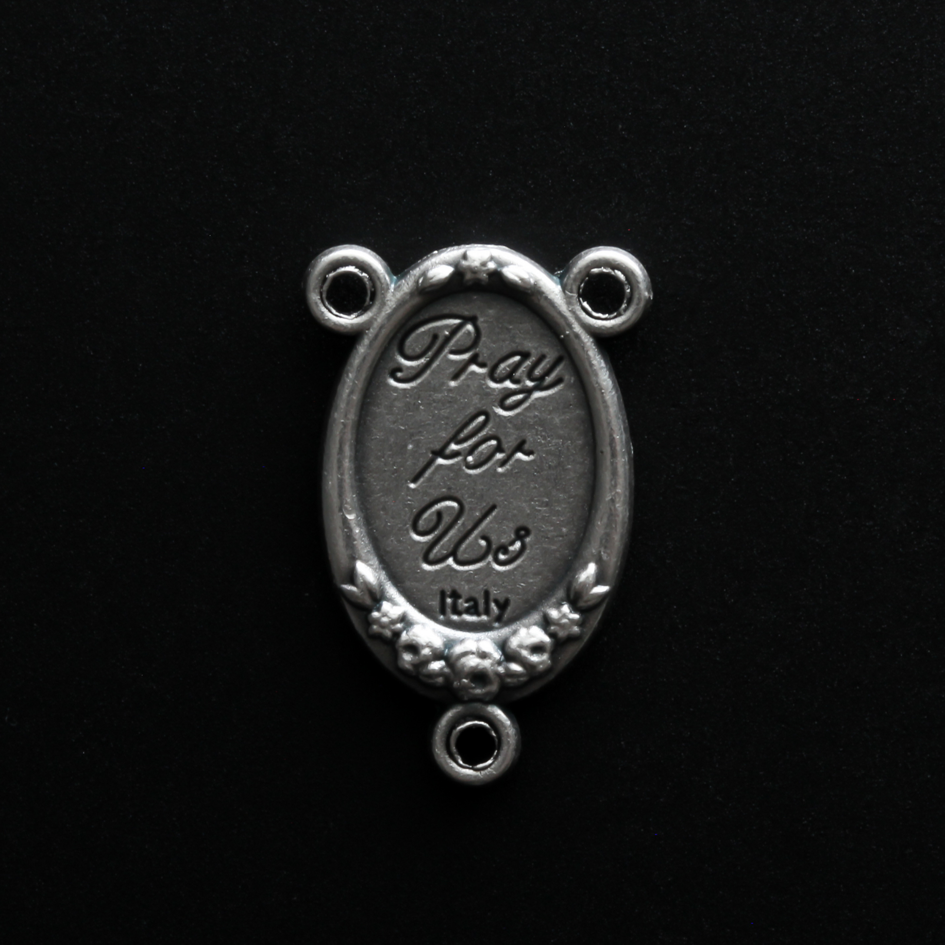 rosary center that has a full-color image of Saint Francis of Assisi inlaid in a silver oxidized center with flower details on the edge