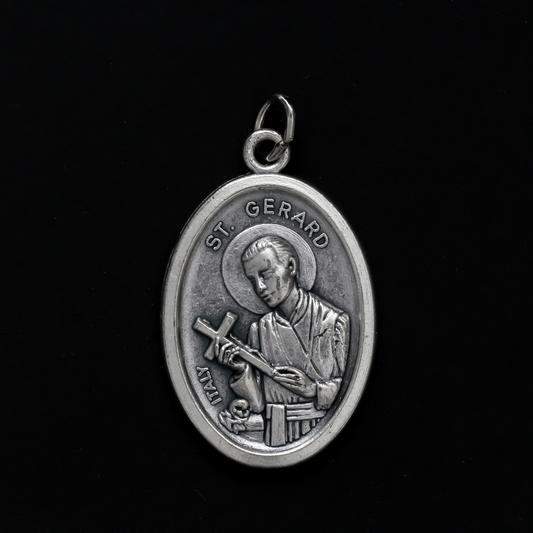 Saint Gerard Majella medal that depicts the saint holding a cross on the front and "Pray For Us" on the back