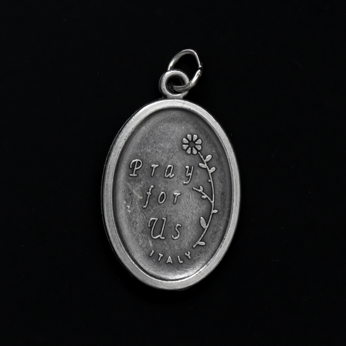Saint Gerard Majella medal that depicts the saint holding a cross on the front and "Pray For Us" on the back