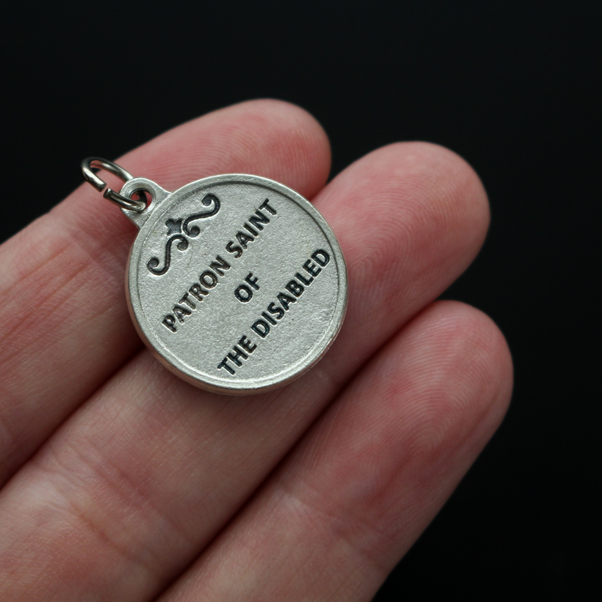 Saint Giles 3/4" round medal. The front depicts the saint and the reverse is marked "Patron Saint of the Disabled".