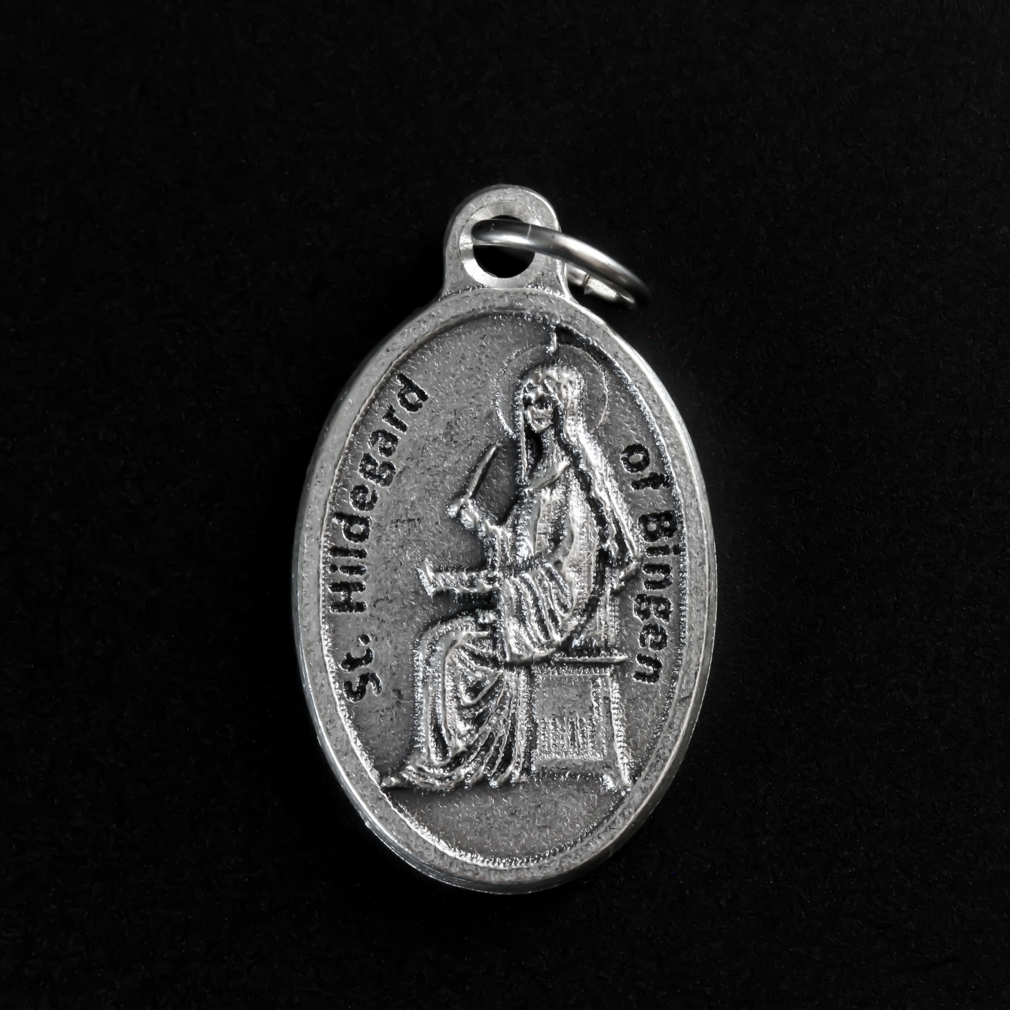 Saint Hildegard medal that depicts the saint on the front and "Pray For Us" on the back.