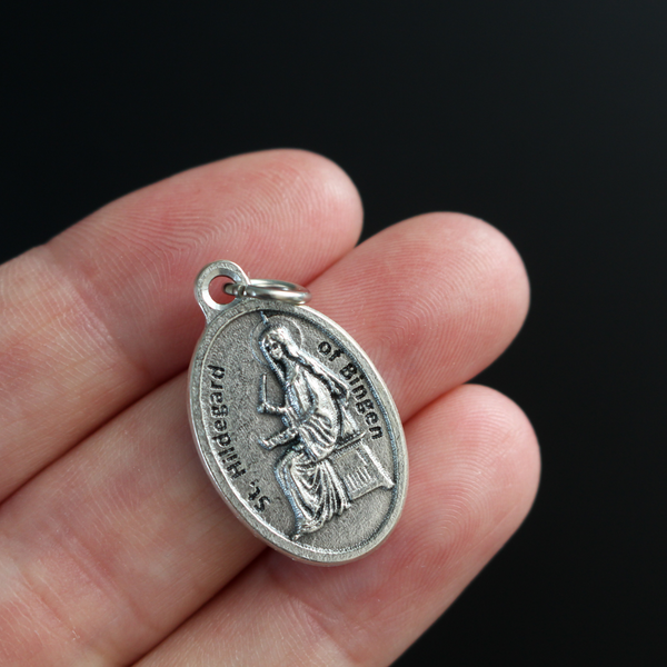 Saint Hildegard medal that depicts the saint on the front and "Pray For Us" on the back.