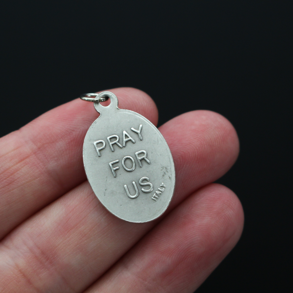 Saint John Neumann medal that depicts the saint on the front and "Pray For Us" on the back.