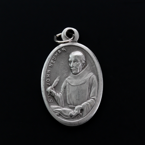Saint John Neumann medal that depicts the saint on the front and "Pray For Us" on the back.