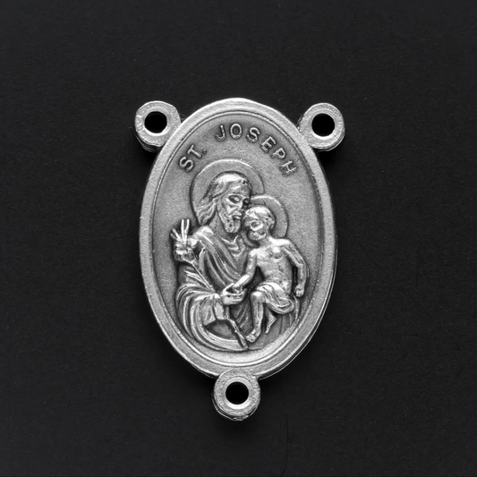 Saint Joseph rosary centerpiece. The front of the medal depicts Saint Joseph holding child Jesus in one arm and a lily in the other. The reverse side is marked "Pray For Us"