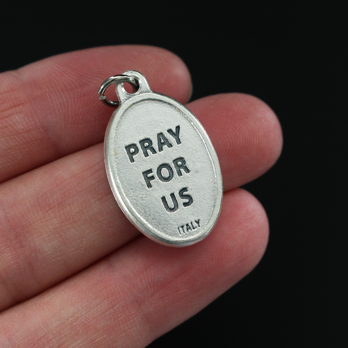 Saint Joseph of Cupertino medal that depicts the saint on the front and "Pray For Us" on the backside