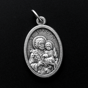 Saint Joseph oval medal that depicts the saint on the front and a cross on the back