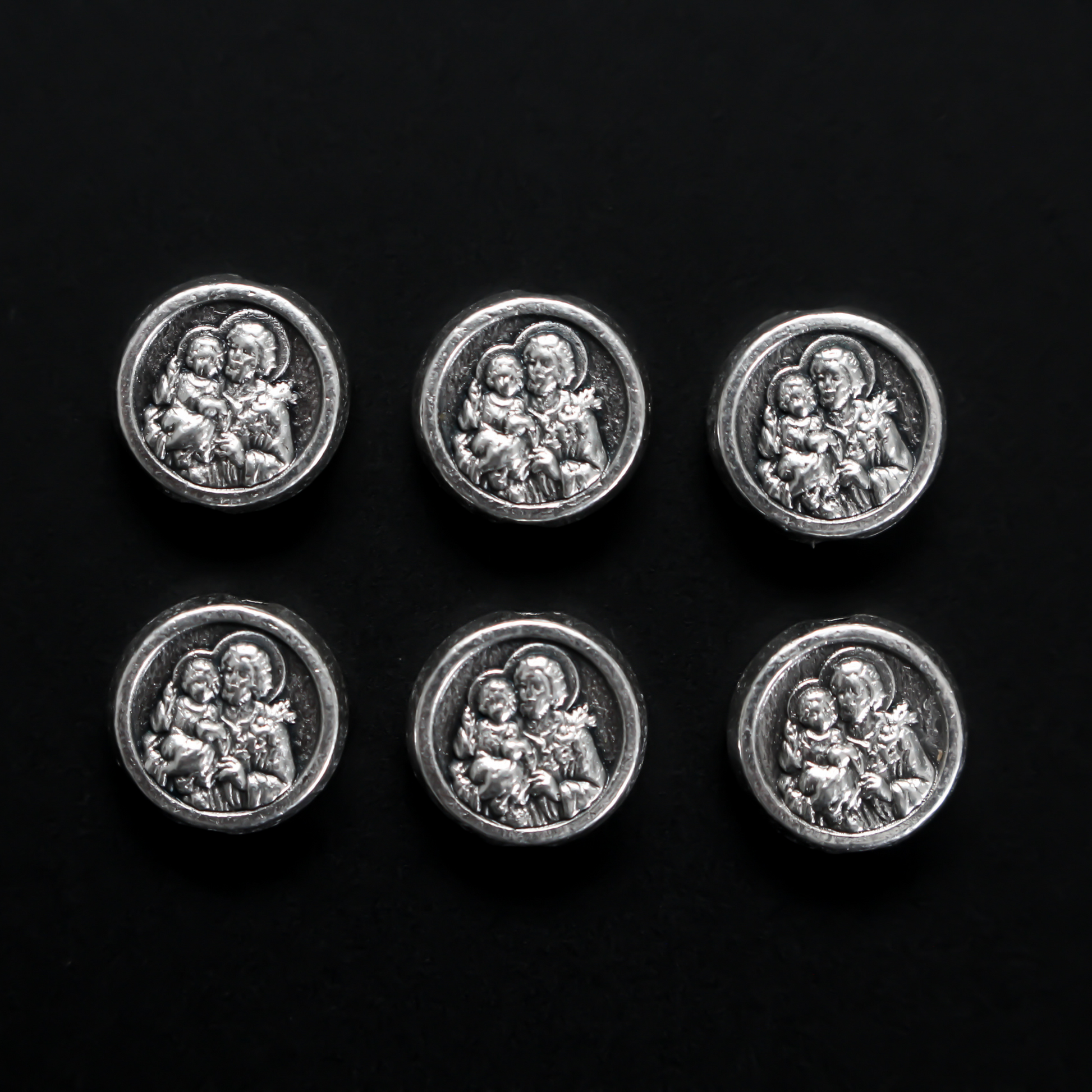 Metal spacer beads with Saint Joseph holding child Jesus on one side and Jesus, Joseph, and Mary on the other side 9.5mm in diameter