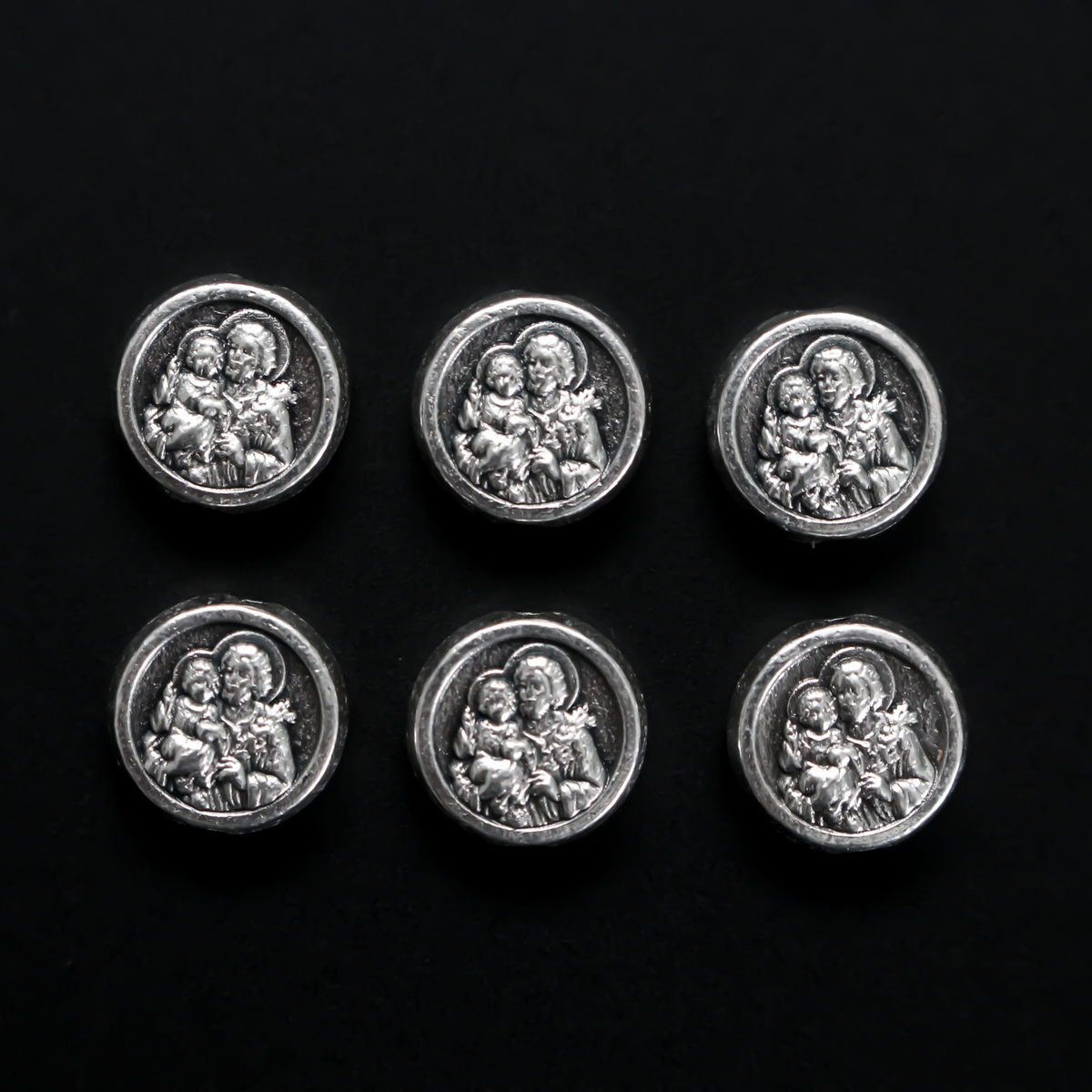 Metal spacer beads with Saint Joseph holding child Jesus on one side and Jesus, Joseph, and Mary on the other side 9.5mm in diameter