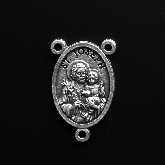 Saint Joseph rosary centerpiece that depicts Joseph holding child Jesus in one arm and a lily in the other