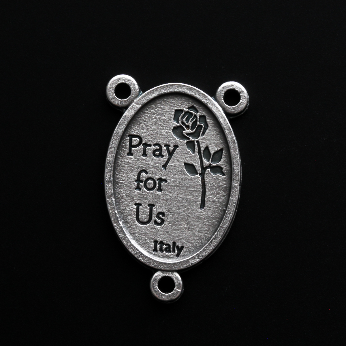 Saint Joseph rosary centerpiece that depicts Joseph holding child Jesus in one arm and a lily in the other
