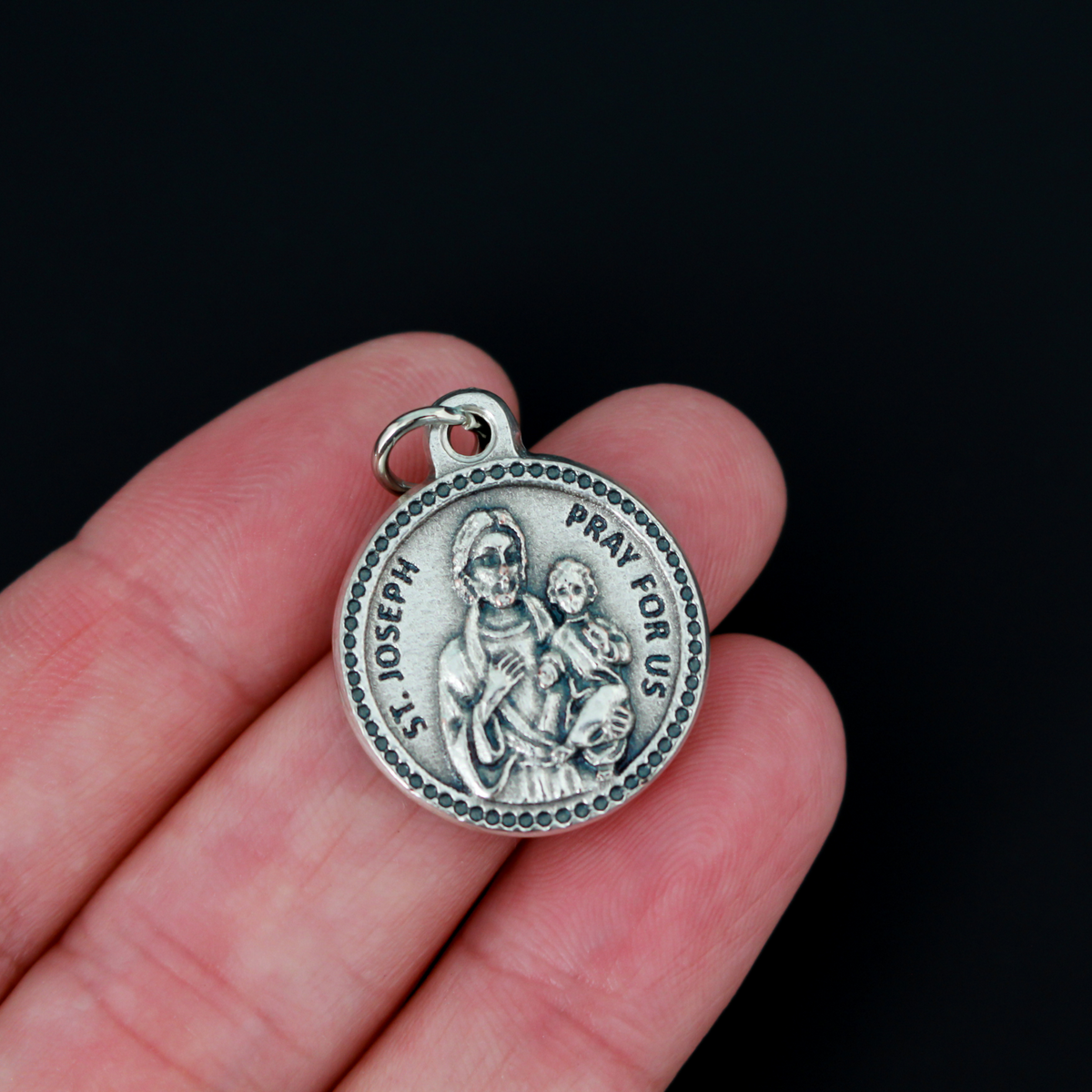 Saint Joseph medal that is round in shape