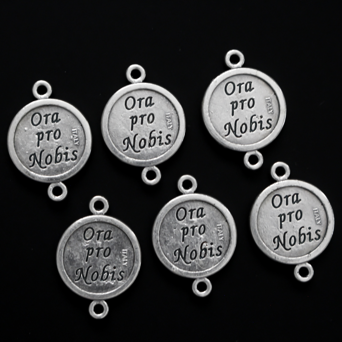 Saint Jude round flat connector links that are silver oxidized plating on a base metal