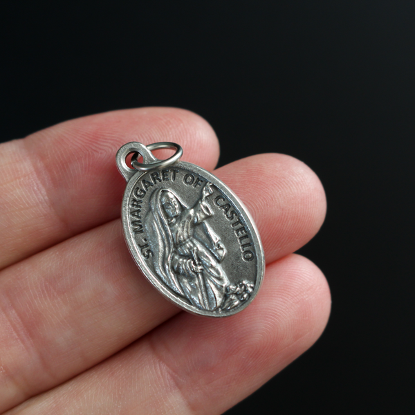 Saint Margaret of Castello medal that depicts the saint on the front and "Pray For Us" on the back