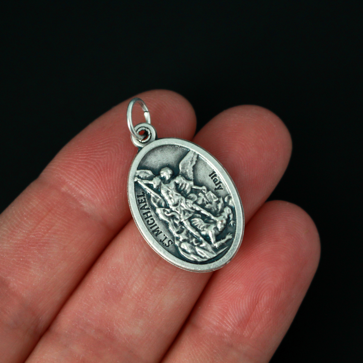 Archangel Michael oval medal. The front depicts St. Michael, the warrior angel of protection and the reverse is marked "Protect Us".