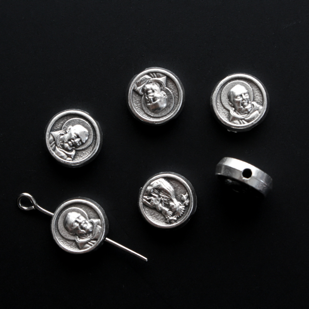 Metal spacer beads that depict Saint Padre Pio on one side and Our Lady of Perpetual Help on the other side.