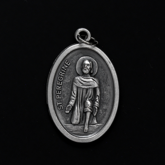 Saint Peregrine medal that depicts the saint on the front and is marked "Pray For Us" on the back