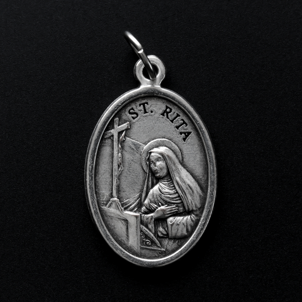 Saint Rita medal that depicts the saint on the front and a beautifully detailed on the back which is a symbol of Saint Rita