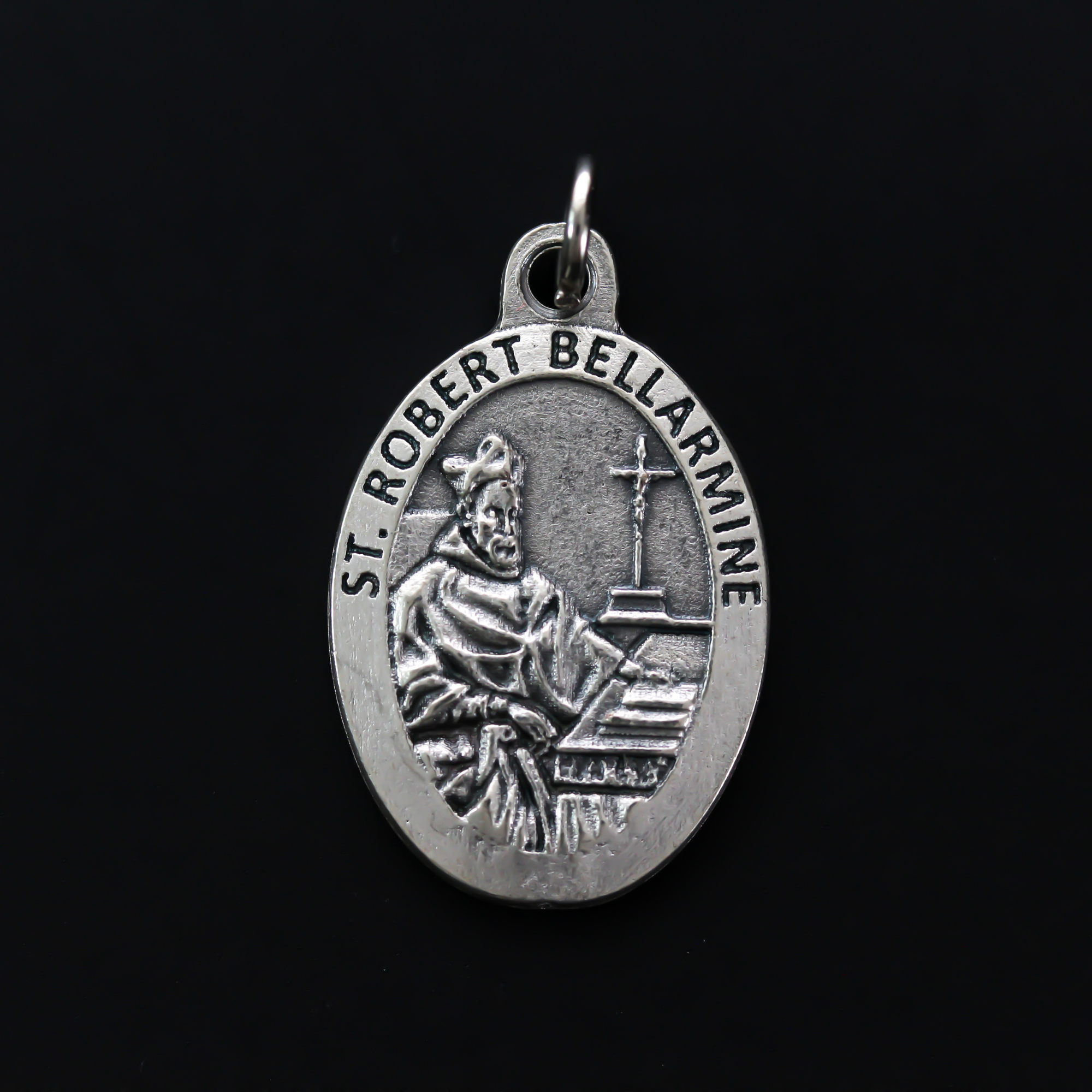 Saint Robert Bellarmine medal that depicts the saint on the front and is marked "Pray For Us" on the back.