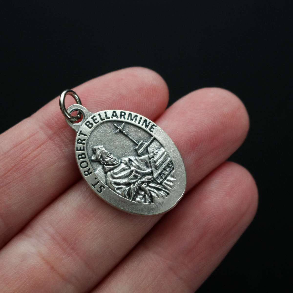 Saint Robert Bellarmine medal that depicts the saint on the front and is marked "Pray For Us" on the back.