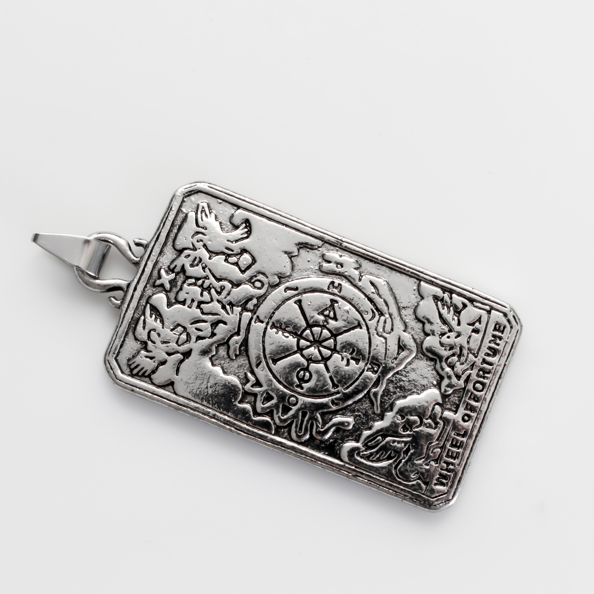 Large tarot card pendant depicting the "Wheel of Fortune" card. There is a jump ring attached to the bail.