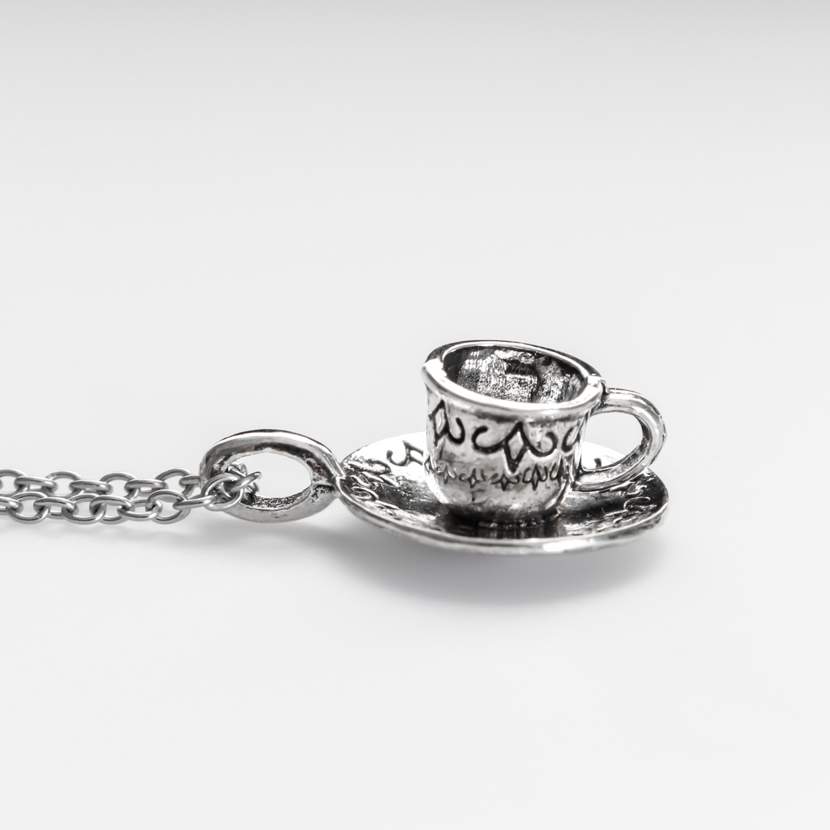 Tiny silver tone cup on a saucer charm. Perfect for coffee or tea lovers! *Necklace is not included*