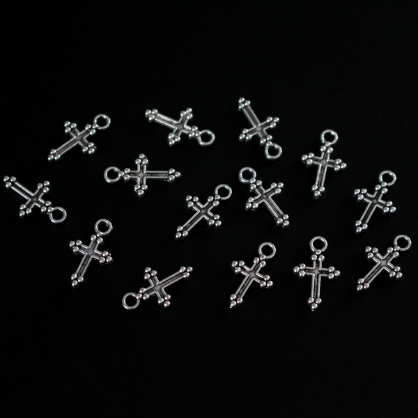 Small antiqued silver-tone cross charms with gothic cloverleaf or budded ends. The ends are symbols of the Holy Trinity, 12mm long