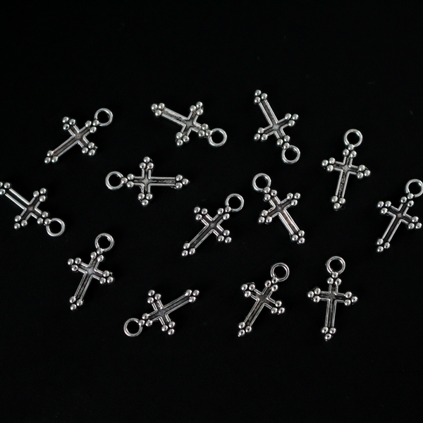 Small antiqued silver-tone cross charms with gothic cloverleaf or budded ends. The ends are symbols of the Holy Trinity, 12mm long